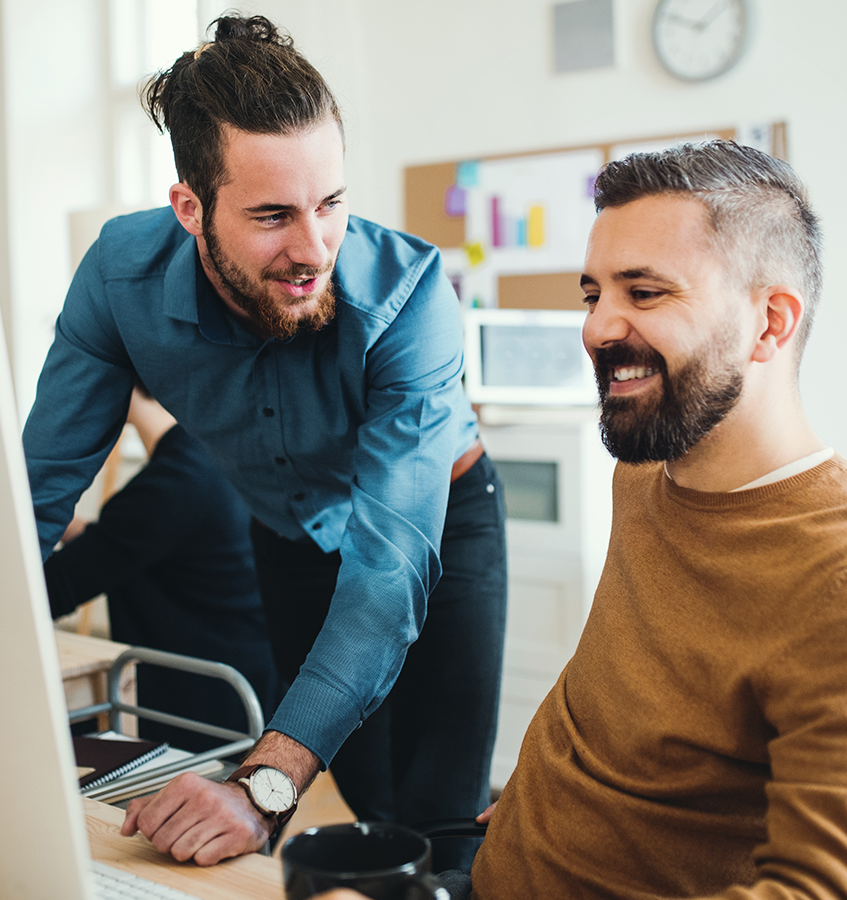 Two men in conversation at the desktop